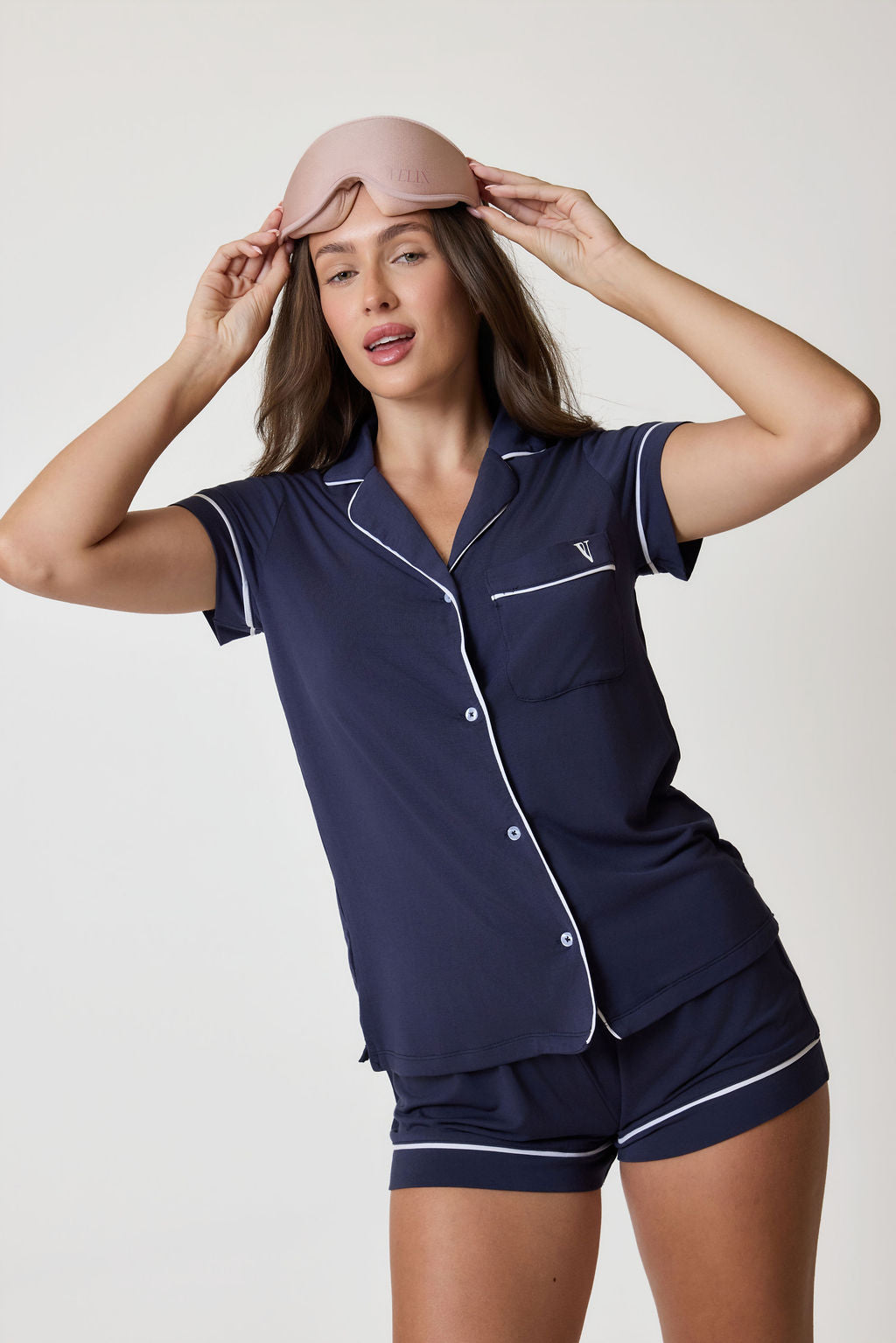Woman wearing pyjama set with white trim. Available in Midnight Navy XS, Midnight Navy S, Midnight Navy M, Midnight Navy L
