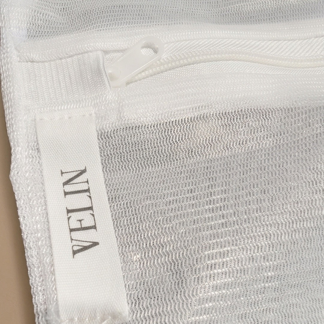 Close-up detail of the VELIN Fabric Care Pouch showing the fine mesh weave and zip closure
